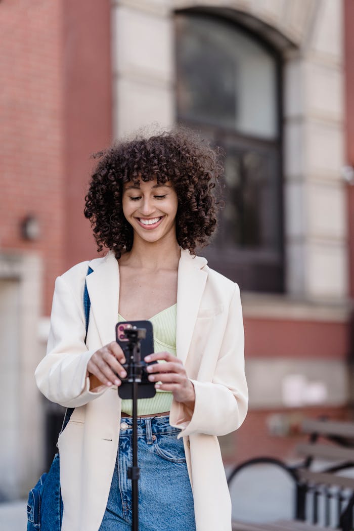 why-choose-us-02 Stylish woman recording vlog on smartphone in a lively city street.